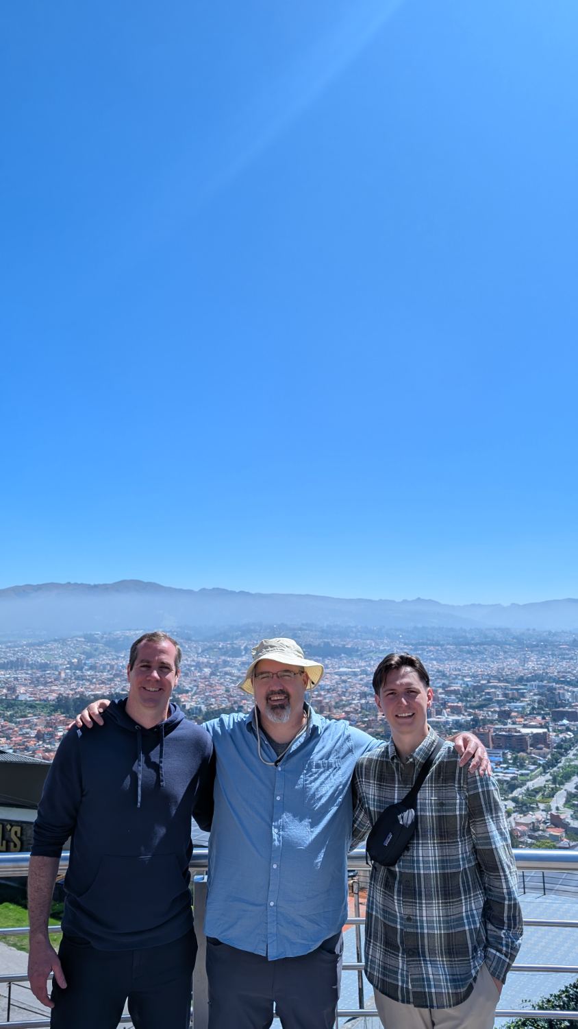 Chris, en el centro, con dos misioneros sobre la ciudad de Cuenca